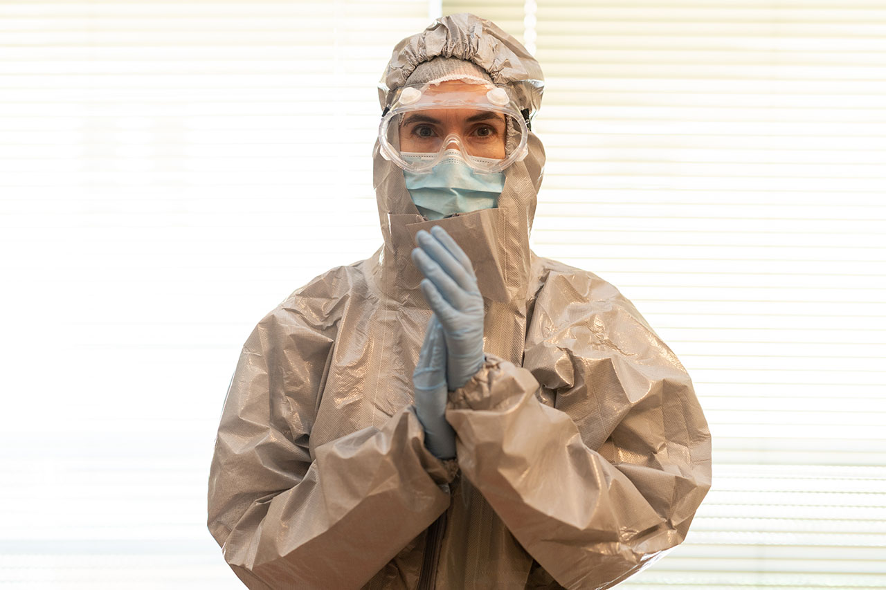 Doctor or lab technician scientist in PPE Personal Protective Equipment clapping